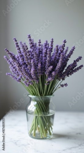 Lavender flowers in a glass vase on a marble table
