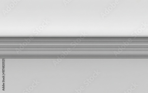 A close-up view of a classic white decorative wall molding or chair rail against a plain background
