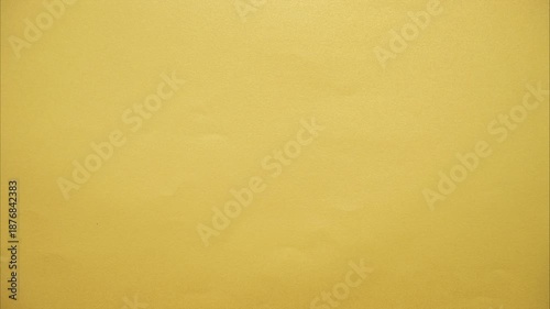 White paper tearing open from the center of the screen, revealing gold paper underneath. Paper tearing from the center as a dynamic transition effect. Stop motion animation