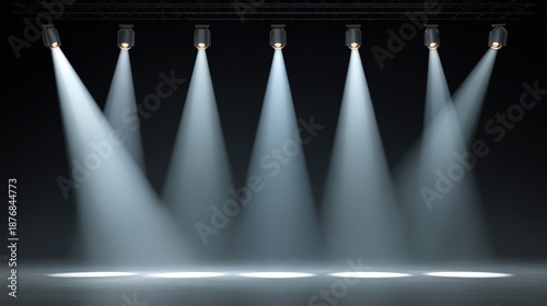 Dramatic stage spotlights shining downward creating intense atmosphere for theater performance lighting design
