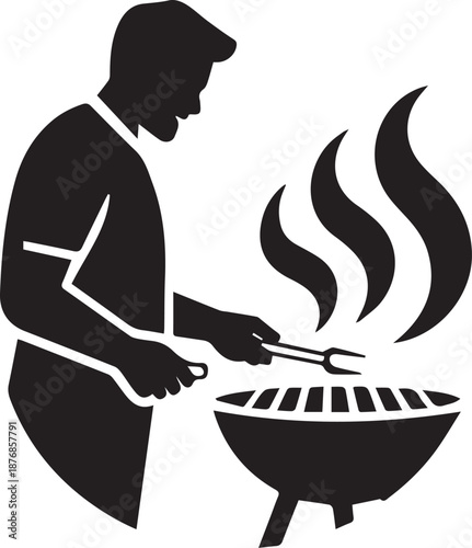 Silhouette of a person grilling meat over flames with tongs