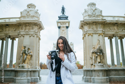 Woman taking photos at El Retiro Park in Madrid