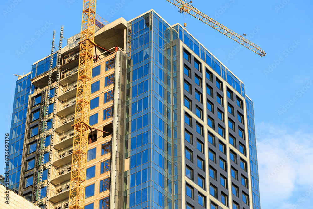 Fototapeta premium urban structure construction multi apartment building industrial process with high rise crane