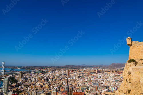 Bilde på lerret A panoramic view of Alicante with sprawling urban buildings under a clear blue sky