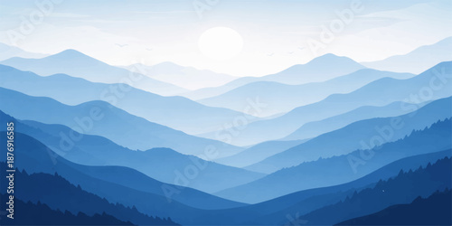 Misty mountain landscape at sunrise with snow-capped Alps peaks and a forest valley under a blue dawn sky featuring clouds and fog over the hills in a panoramic nature view