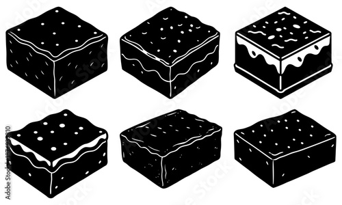 Six black chocolate cake squares with white drizzle on white background