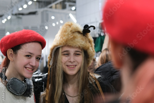 Two teenage friends are shopping for warm winter clothes.