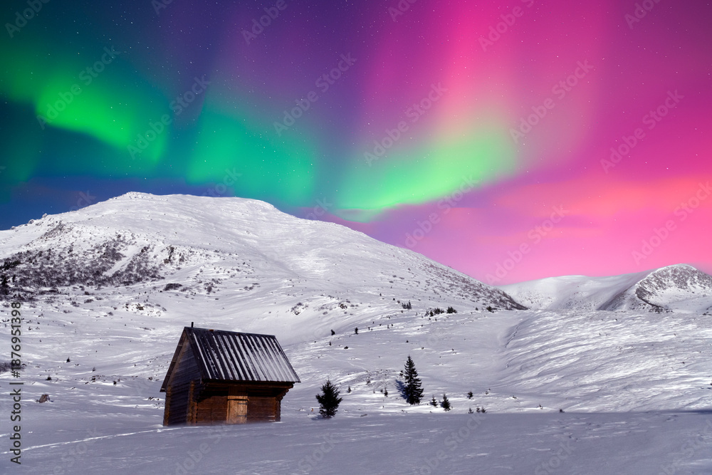 Obraz premium Christmas landscape with Polar lights in winter time. Small wooden cabin in snowy mountains under incredible Northern lights in starry sky. Aurora Borealis