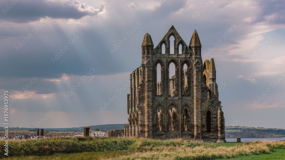 Fototapeta premium Old Gothic Monastery Near Stormy Sea, Weathered Stone Arches Along Windswept Shoreline Landscape