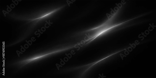 Luxurious black and white silk fabric flowing in soft purple and blue waves creates a smooth satin background texture with a motion of light for an elegant wallpaper design