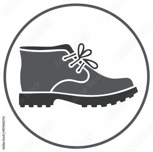 Monochrome vector icon of a rugged ankle boot with laces and a treaded sole in a circle
