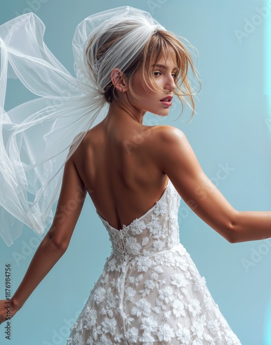Elegant bride in a flowing lace wedding dress with veil in motion, graceful feminine portrait, modern bridal fashion concept, romantic beauty, soft light, luxury wedding style.