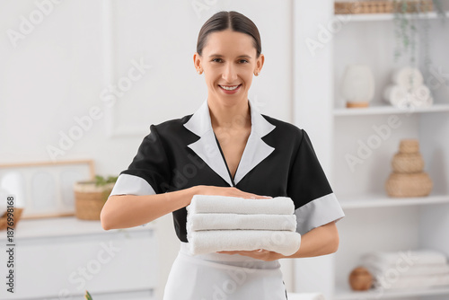 Young chambermaid with clea...