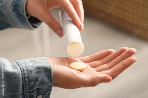 Woman taking vitamin C pill...