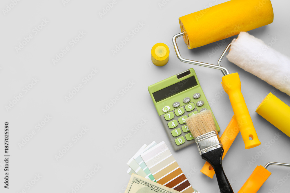 Obraz premium Composition with calculator and painting tools on grey background. Renovation budget concept