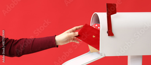 Woman taking letter with pa...