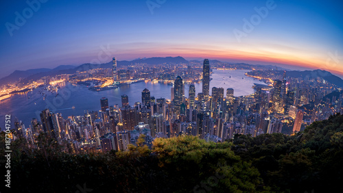 Photography HongKong skyline at blue hour overlooking harbor, panoramic cityscape with glowi