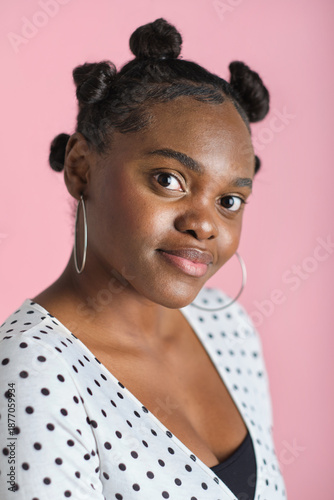 Photography confident Young black woman posing in studio with bantu knots