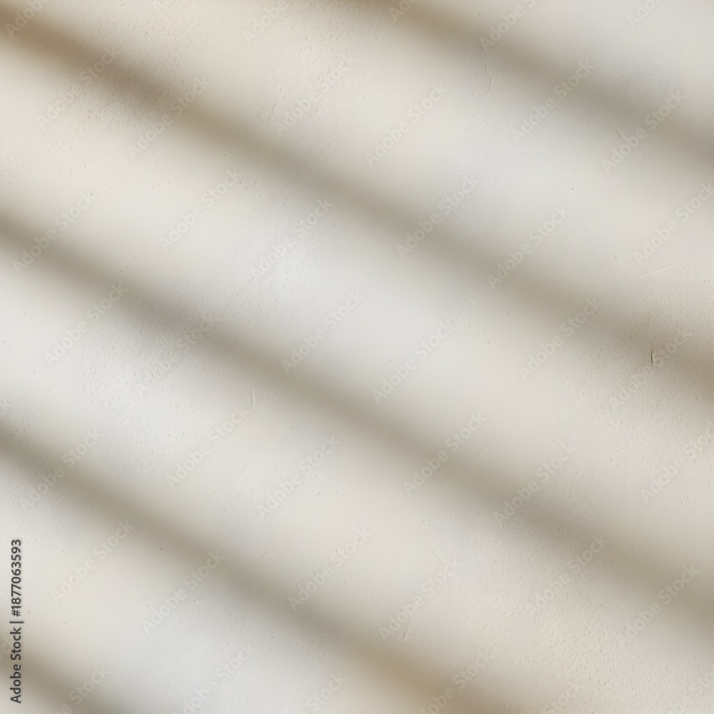 Fototapeta premium Soft diagonal shadow lines cast across a neutral textured wall, creating a subtle abstract pattern.
