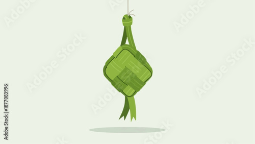 Green leafy vegetable hanging from a string, possibly a herb or vegetable bundle.