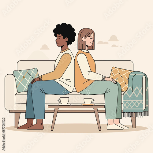 Couple sitting back to back on sofa, facing away from each other