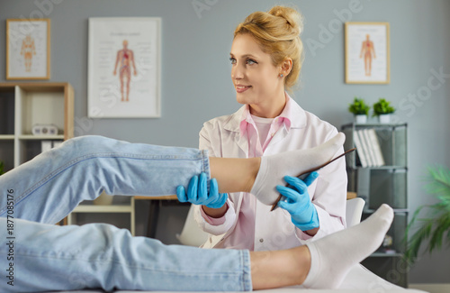 Slika na platnu Podiatrist examines a patient foot in clinic, fitting orthopedic inserts