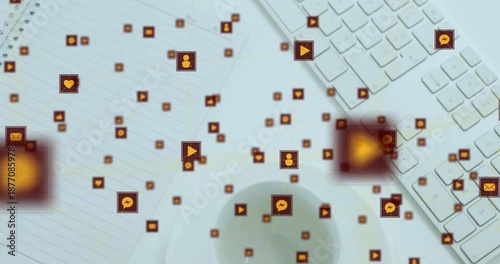 Floating network of orange social icons connecting over workspace, showing keyboard, notebook, cup