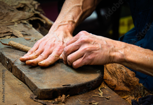 A cigar maker hand rolls premium cigars at a small US manufacturer