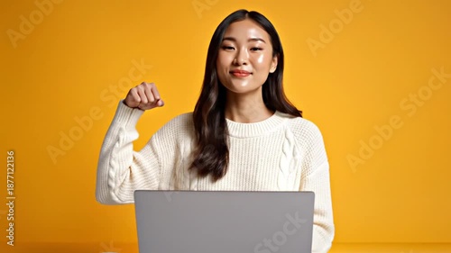 Excited Asian Woman Celebrating Success on Laptop with Various Expressions and Gestures on Yellow