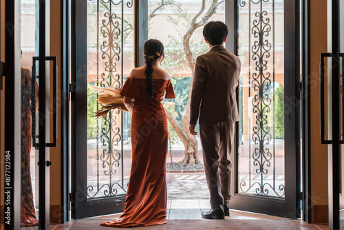 Wedding reception, after-party, bride and groom appearing in wedding color dresses, dressed-up couple