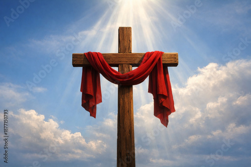Wooden Christian Cross Draped with Red Cloth Against Blue Sky and Clouds