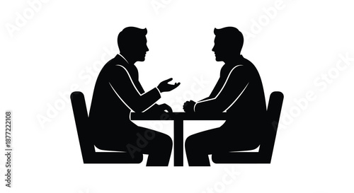Two men in suits are seated at a table facing each other in silhouette