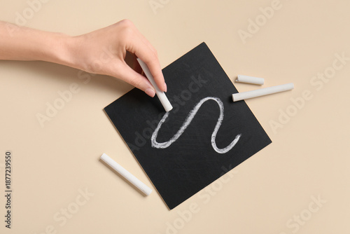 Woman drawing line with whi...