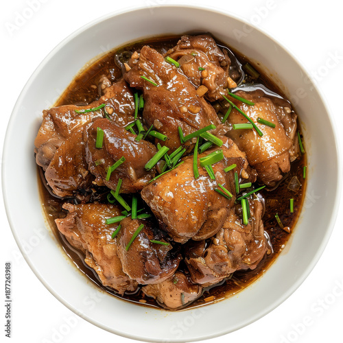 Delicious chicken adobo with fresh chives in a white bowl, top view isolated on white background