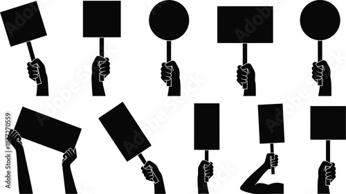Hands holding protest signs and placards in black silhouette