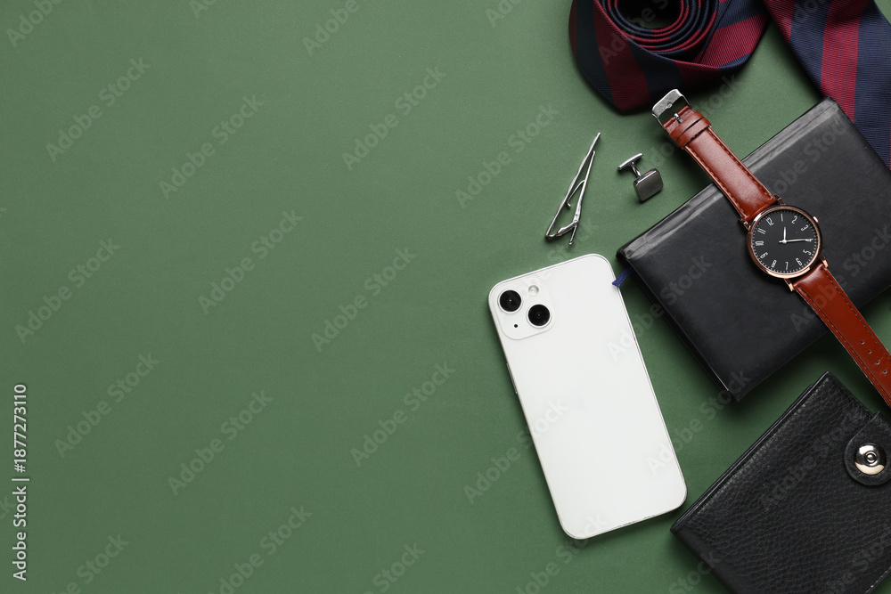 Naklejka premium Different male accessories with mobile phone on green background