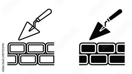 Applying mortar to brick wall with trowel