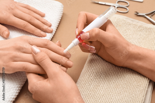 Manicure master applying cu...