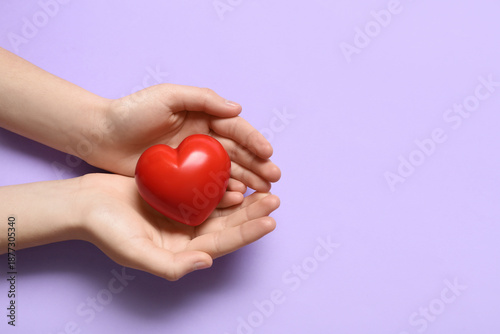Female hands with red heart...