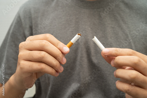 Man holding cigarette, no smoking.