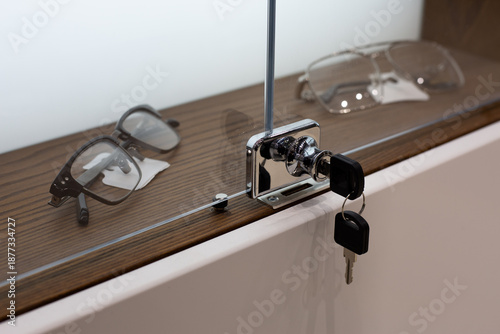 Fényképezés Glass cabinet with glasses behind closed transparent doors