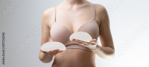 Quadro su tela Female holding silicone breast implants in hands