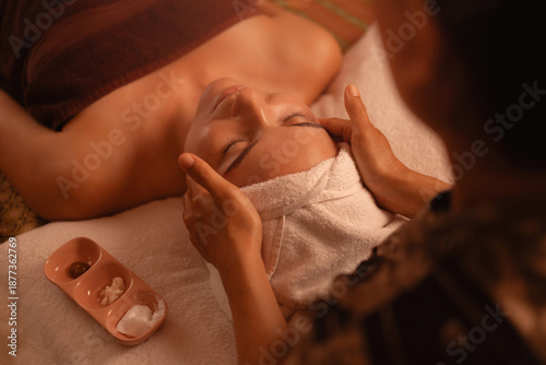 Quadro su tela Relaxing thai massage for young caucasian female with head towel in spa setting