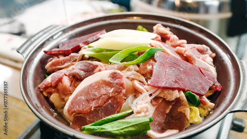 Fotografie Traditional Japanese sukiyaki or hot pot with raw meat and vegetables