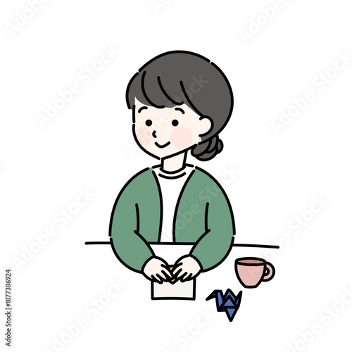 折り紙を折る女性