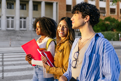 Quadro su tela Diverse group of college students standing outdoors on university campus, holdin
