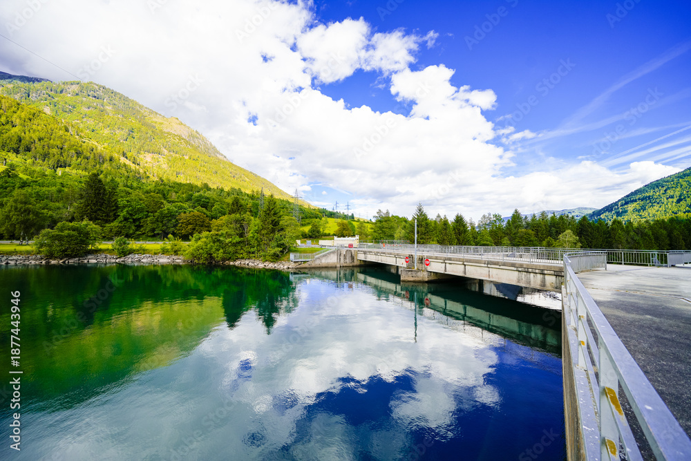 Fototapeta premium View of the Rottau reservoir and the surrounding green landscape. Nature by the lake near Mühldorf in Austria. 