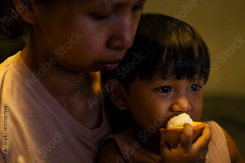 Close Up Mom And Toddler Are Eating Santol