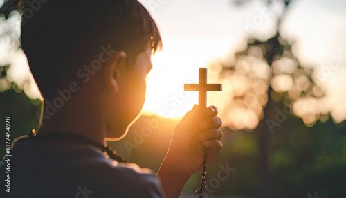 Child Holding Cross in Spiritual Portrait at Sunset