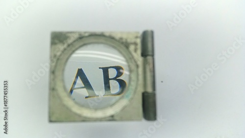 Close-up of Optical Magnifier Zooming in on Alphabet Letters